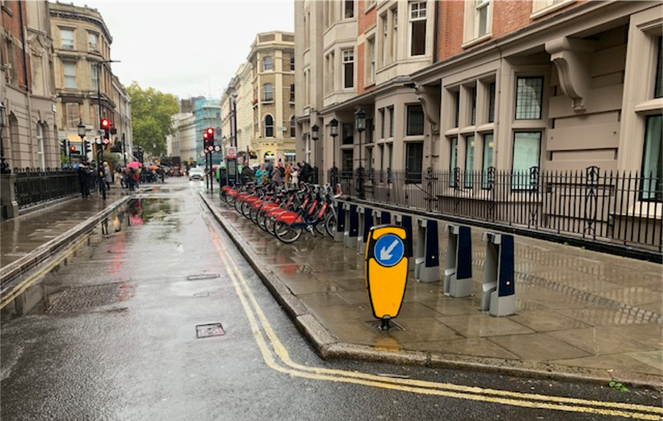 cycle hire docking station on a wide section of pavement on Great Russell Street