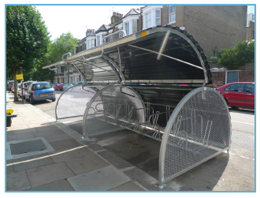 example bike hangar - where a secure bike rack with liftable cover sits on the road with storage for numerous bikes