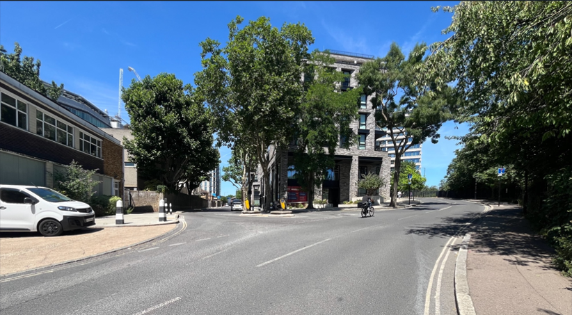 Wide road junction with some trees 