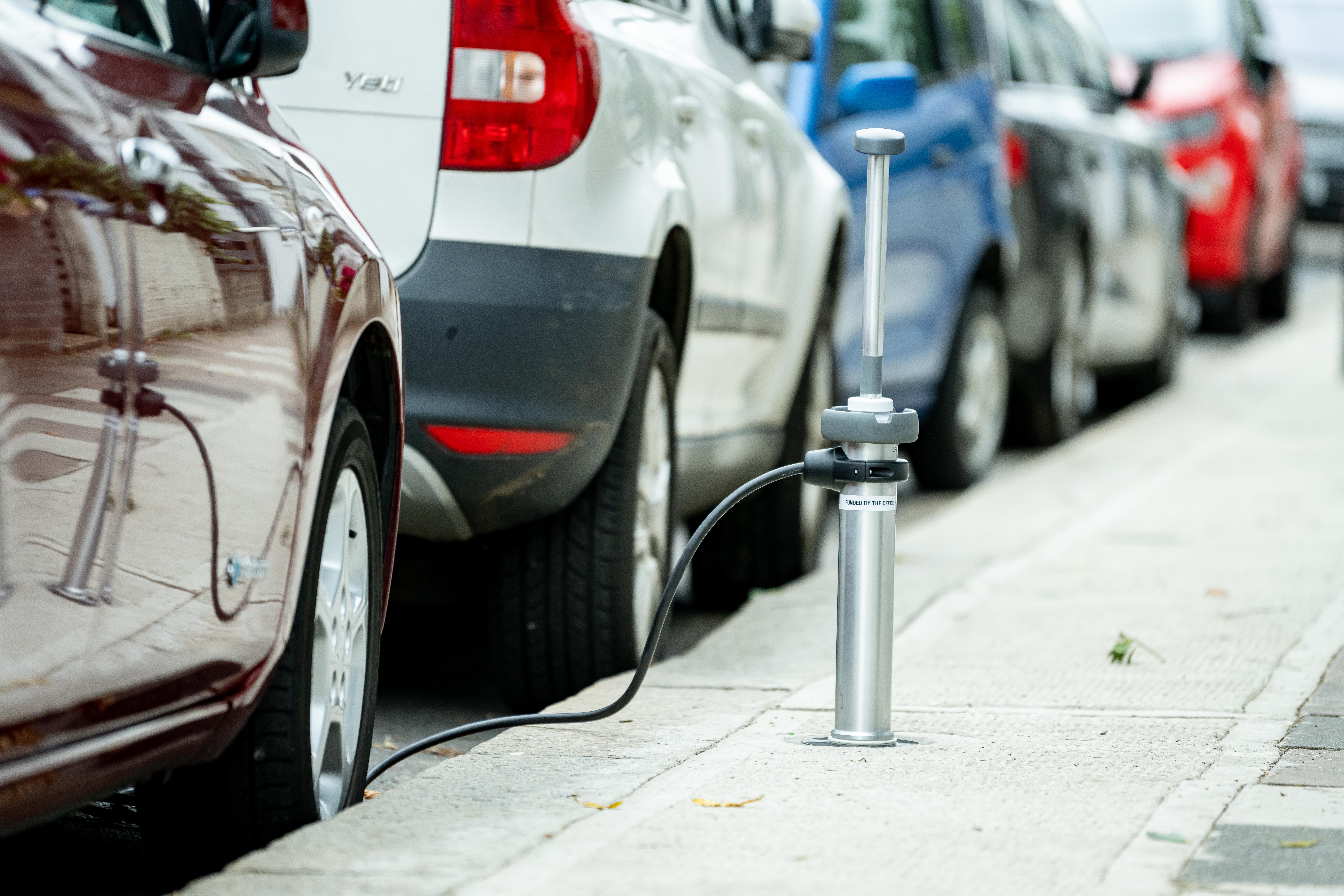 Image of a electric vehicle charging point which looks like a rod which comes out of the pavement