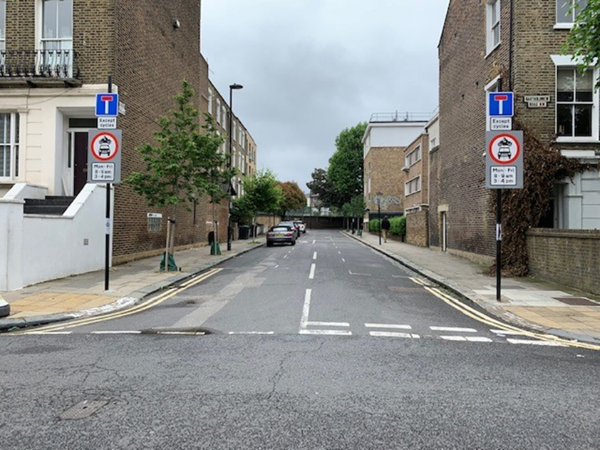 Healthy school street which is a simple street with two signs showing the times when vehicles cannot enter but that cycles can enter at anytime