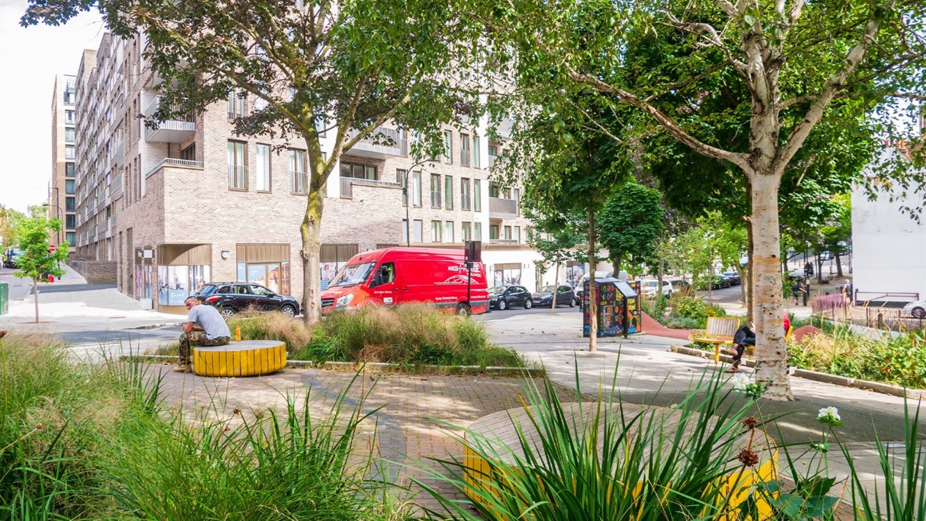 Pocket park with planting, seating and people relaxing