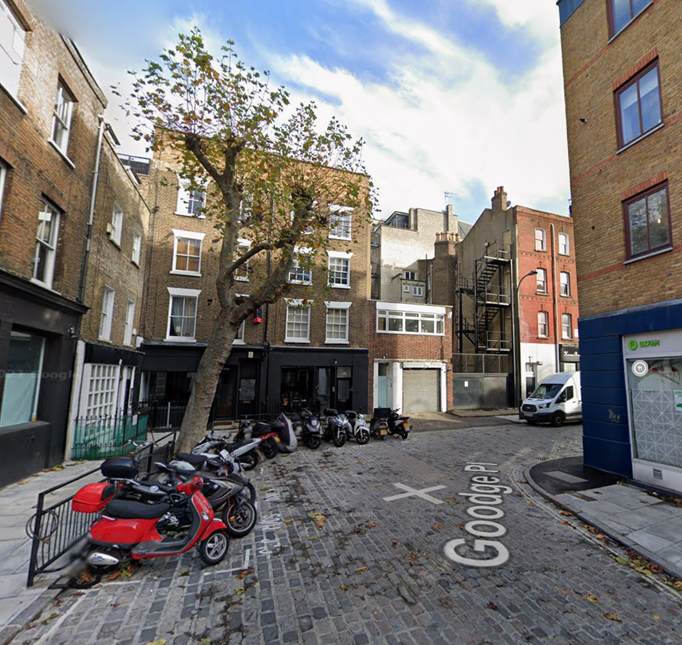 Goodge Place with motorbike parking and cobbled road surface