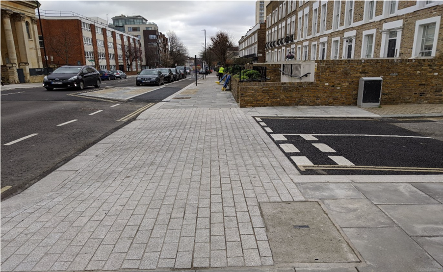 Continuous pavement where the pavement material continues across the road