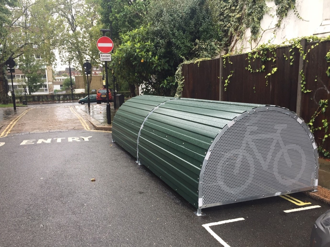Cycle hangar in green a curved metal 