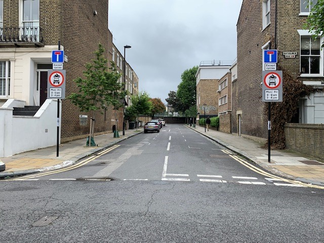 Image of a street which has signage showing the times when traffic cannot enter